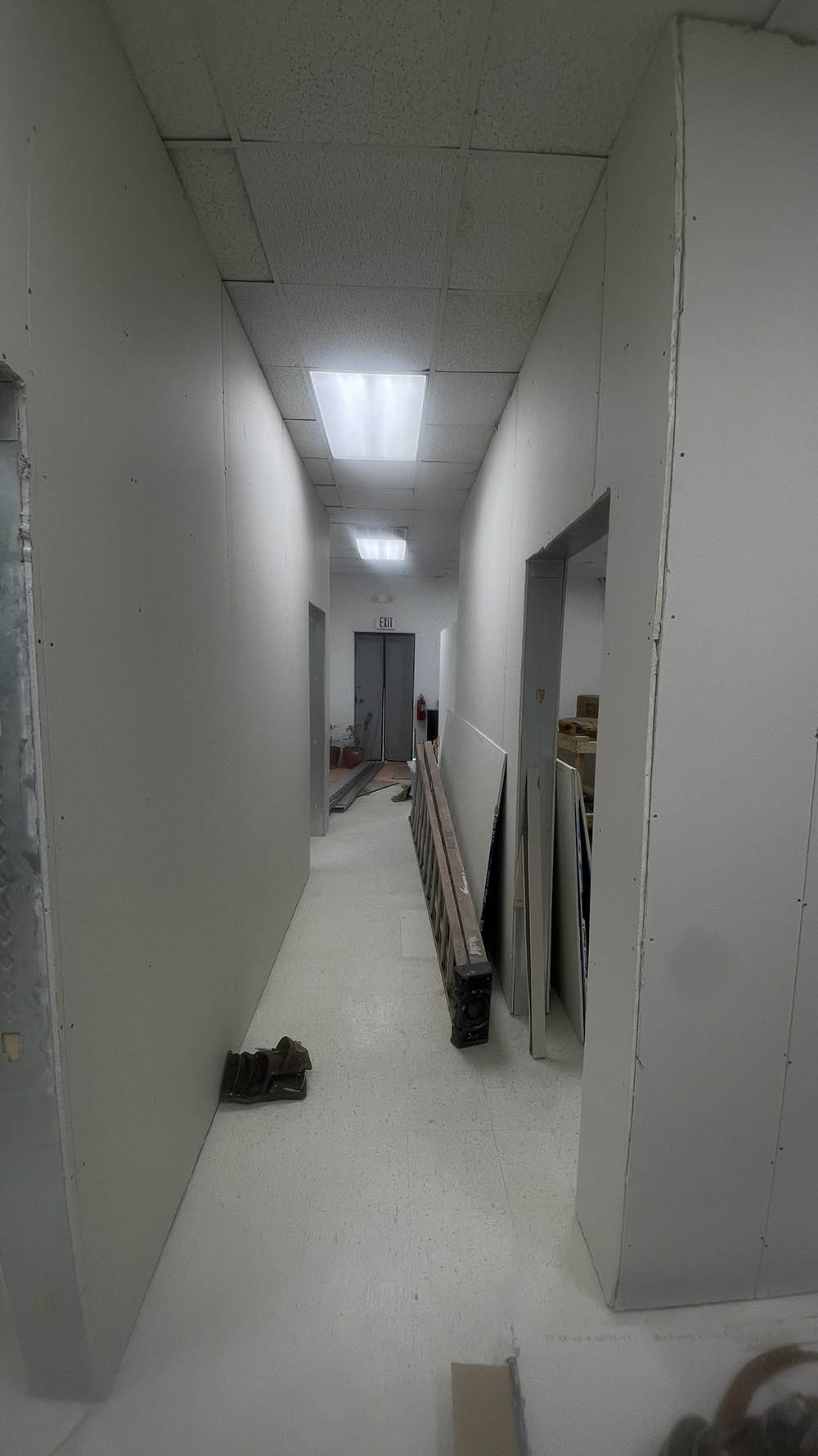 Commercial drywall panels hung along long corridor walls